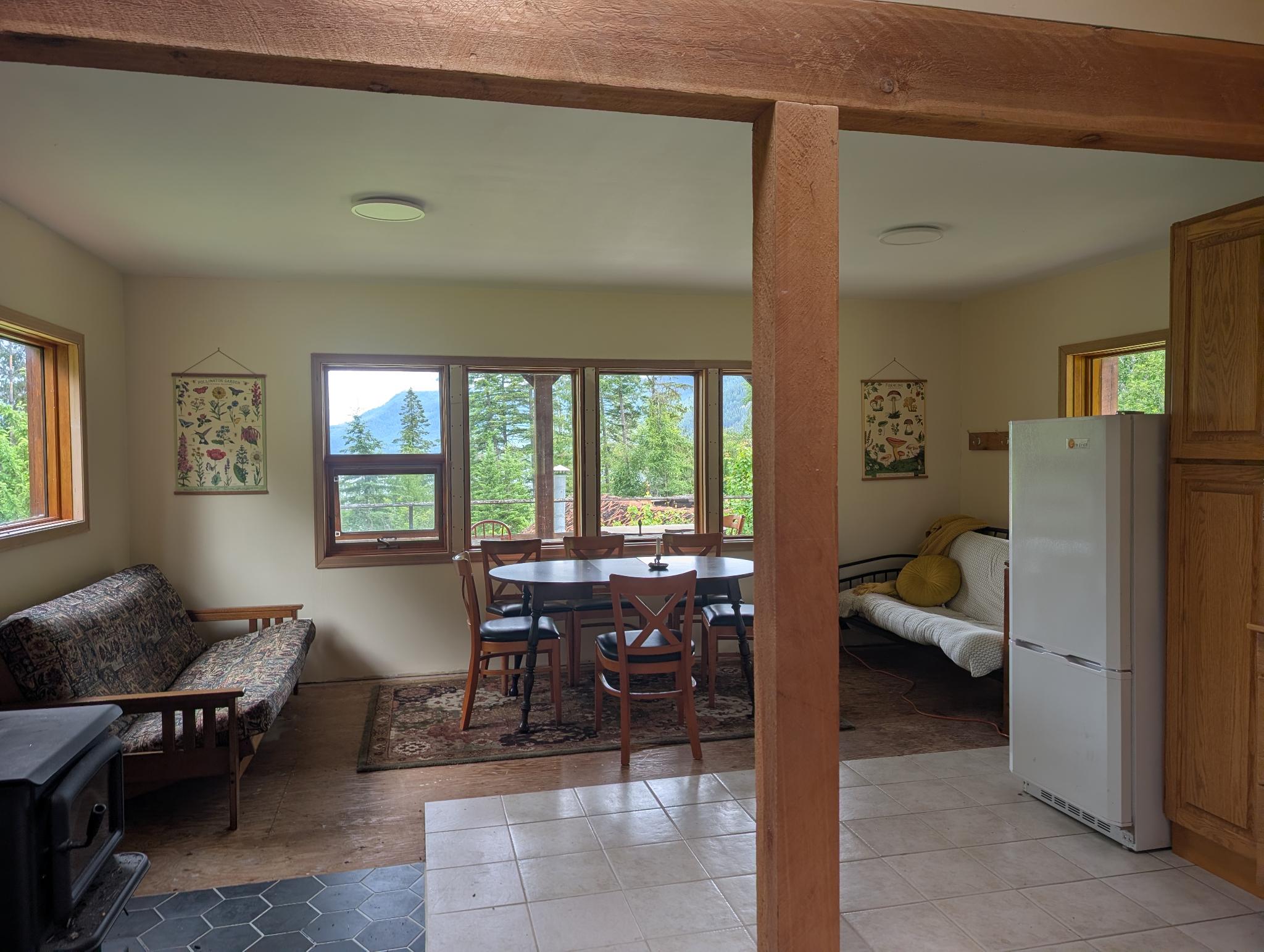 Sunlit common room with mountain-view windows