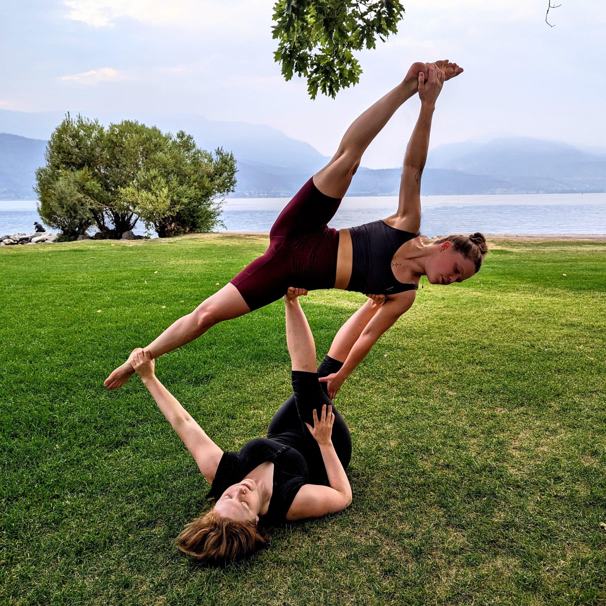 Partner acro on green grass